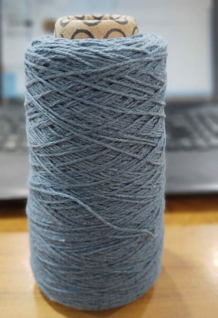 Cotton polyester blend melange carpet yarn cone in blue heather shade for carpet weaving